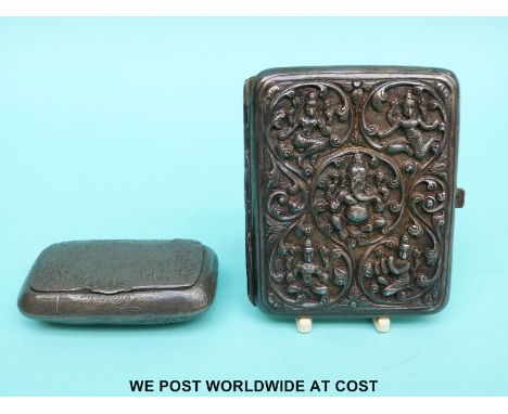 An Indian white metal cigarette case with deep embossed decoration of Hindu gods including Ganesh, probably late 19th/ early 