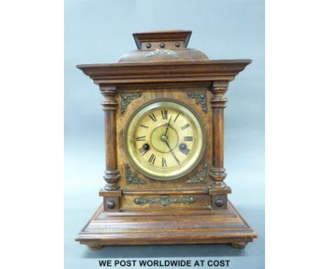 A German Wurttemburg mantel/shelf clock in wooden case with turned decoration and inset brass spandrels, Roman numerals and b