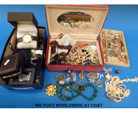 A collection of costume jewellery to include a silver stick pin set with pressed amber, brooches including filigree, Monet an