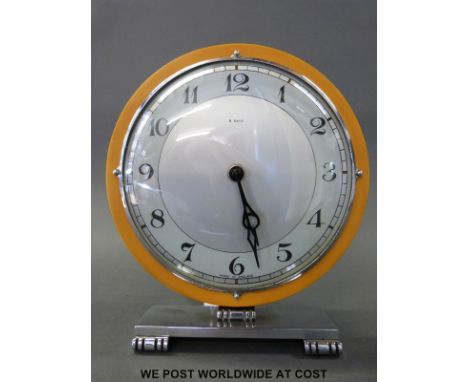 A retro 8 day English mantel clock, 15cm dial, Arabic numerals, stylised hands raised on chromium plated stand 