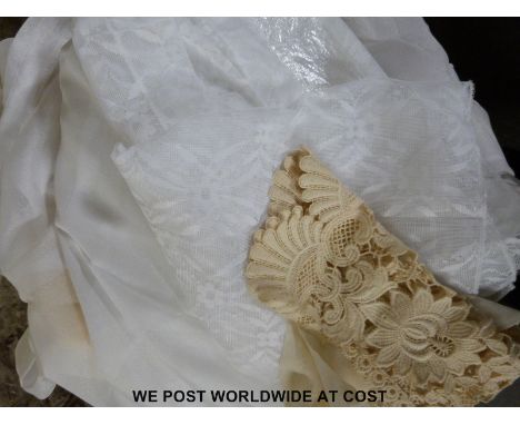 Two boxes of net curtains and similar material