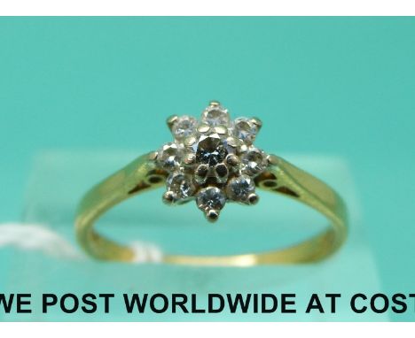 An 18ct gold ring set with diamonds in a cluster (size M)