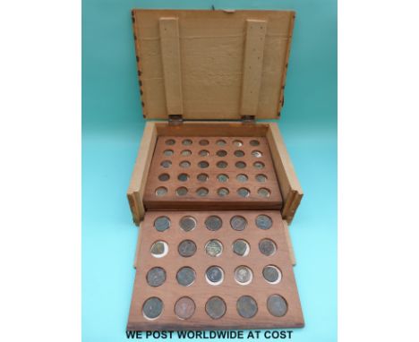 A small coin cabinet containing a quantity of Roman coins