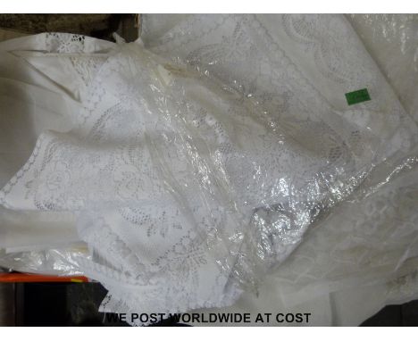 Three boxes of net curtains and similar material