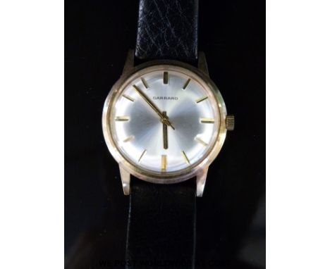 Garrard 9ct gold gentleman's wristwatch with gold hands and baton markers and engine turned face, on black leather strap, cas