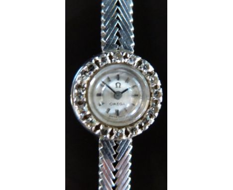 Omega 18ct white gold ladies wristwatch with sixteen diamonds inset to the bezel, black hands and engine turned case, case di