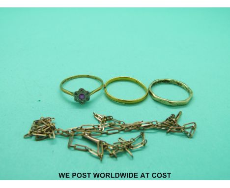 A yellow metal ring marked 18ct gold set with a ruby surrounded by diamonds (1.7g);  22ct gold wedding band (2g); 9ct gold we