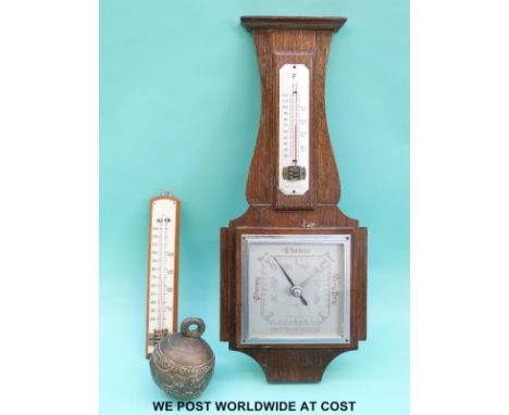 A c1930 aneroid wall barometer together with a thermometer and a brass elephant bell