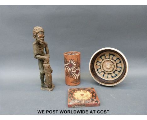 A studio pottery dish, cylindrical vase, terracotta tile and Africa figure