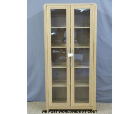 A glazed light oak display cabinet (W90 x D42 x H190cm)