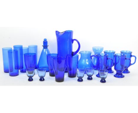 A collection of vintage and late 20 the century blue glass. To include glass jugs x 2 (one Whitefriars), Irish coffee glasses