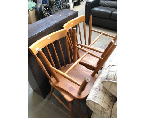 A set of four light wood chairs. 
