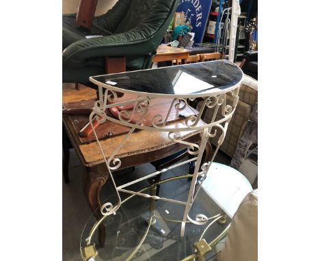 A black glass and metal frame console table. 