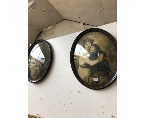 A pair of portrait prints in oval frames 
