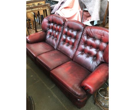 An Oxblood leather chesterfield sofa. 