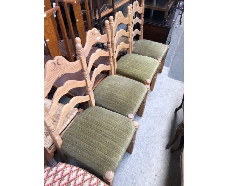 A set of four light oak ladder back chairs. 