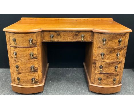 A Pine twin pedestal writing desk, oversailing top above single frieze drawer, four bow front drawers either side, Walnut ven