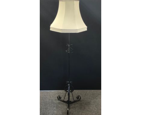 A wrought iron floor standing lamp, painted black, 175cm high