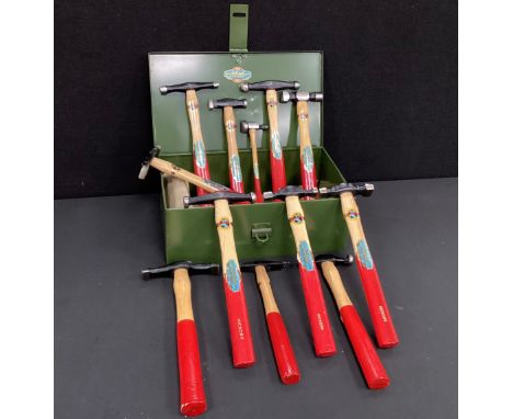 An Altas Forge domestic tool box containing; hickory handled silversmithing hammers, in khaki metal box.