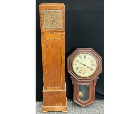An Arts and Crafts longcase clock, copper planished face, 135cm high; an early 20th century American wall mounted clock, 80cm