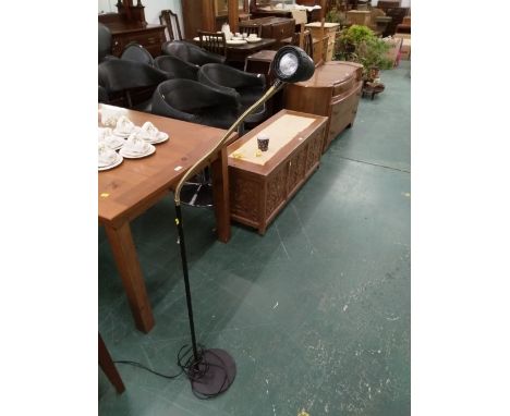 A black plastic and metal floor lamp 
