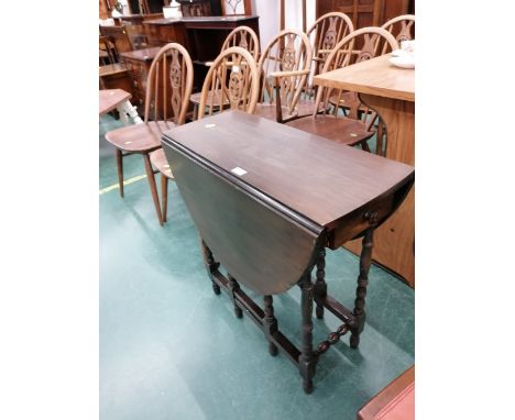 A mahogany drop leaf table with gate leg 