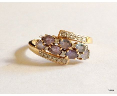 A 9ct gold amethyst and diamond cluster ring size U