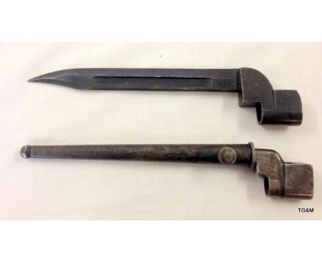 A number 4 Mark 2 British spike bayonet in its steel scabbard and a Number 9 Mark 1 bayonet with War Department arrows