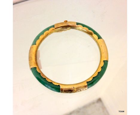 A Jade and yellow metal bangle