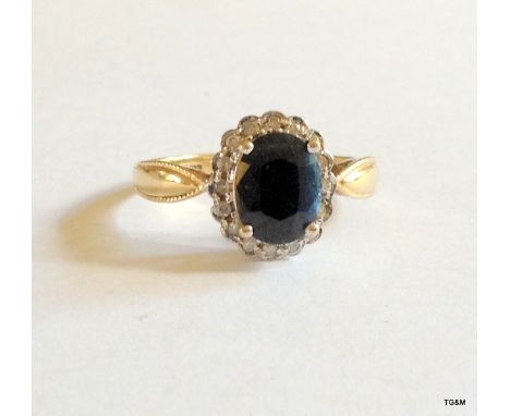 A 9ct gold blue sapphire and diamond cluster ring size N