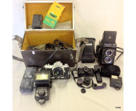 A vintage Yashica 124 box camera, a Nikon SLR camera and a Pentax 110 and various Flash Lightmeters etc.