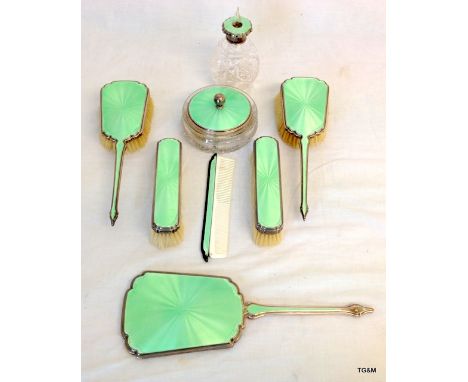 A silver dressing table set with engineered enamel to include pot, mirror, perfumery, brushes and comb