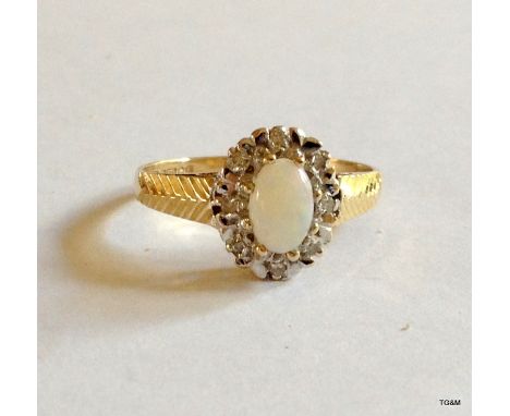 A 9ct gold opal and diamond ring size J