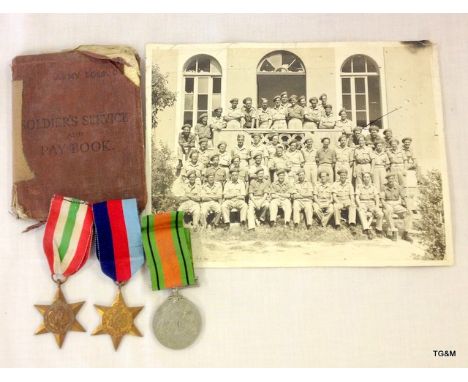 A WW2 medal group of three including the Italy Star his Pay Book which confirms the medals to 14532662 Gunner R Bryant-Jeffer