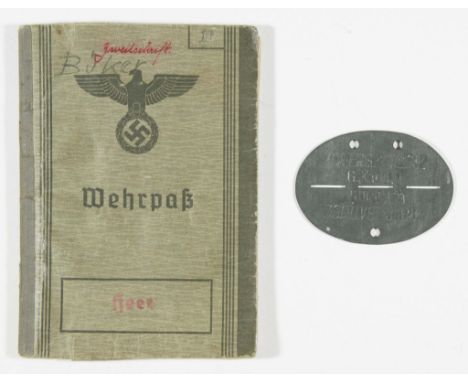 A German Heer 'wehrpass' of Franz Georg Wilhelm Buker, born, January 1, 1915, bearing his personal information and identifica