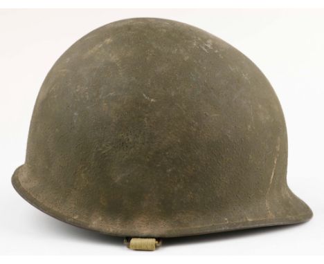 United States Army relic M-1 steel helmet with a sewn-on chinstrap indicating this is a World War II era helmet, lacking the 
