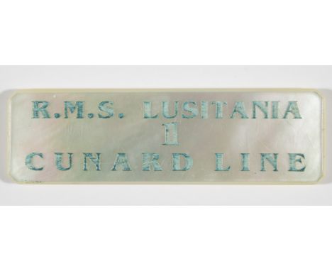 LUSITANIA TABLE ASSIGNMENT RMS Lusitania table assignment token, 2 3/8 in. wide, made of mother of pearl and engraved: 'R.M.S