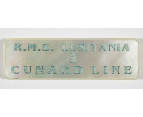 LUSITANIA TABLE ASSIGNMENT RMS Lusitania table assignment token, 2 3/8 in. wide, made of mother of pearl and engraved: 'R.M.S