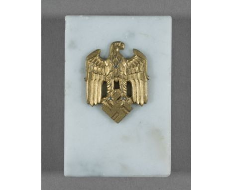 EAGLE AND SWASTIKA PAPERWEIGHT Desk paperweight, 2 x 3 x .75 in., white marble with a gilt national eagle with swastika affix