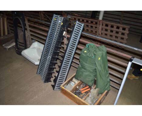 Three drainage channels; a small tent and a crate of hand tools 