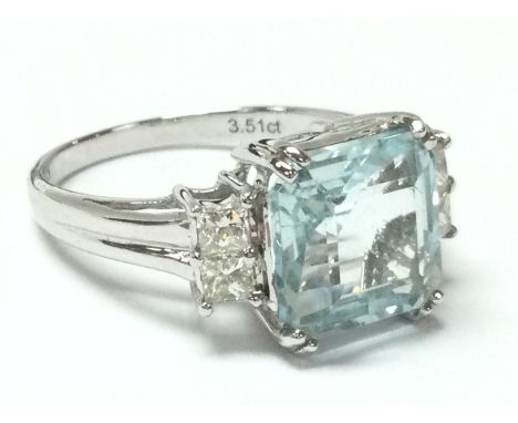 18ct white gold ring set with an asscher-cut aquamarine with princess cut diamond shoulders. Aquamarine 3.51ct. Diamonds 0.28