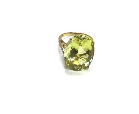 A 9ct gold ring set with large pale green stone. Size M and 6.46g. Postage A