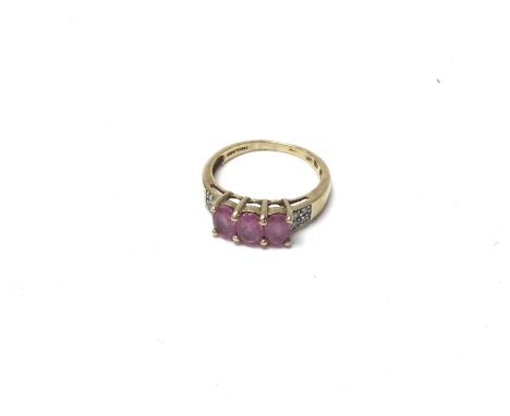 A 14ct gold ring set with three pink oval rubies and diamonds. Approx 2.87 grams M.