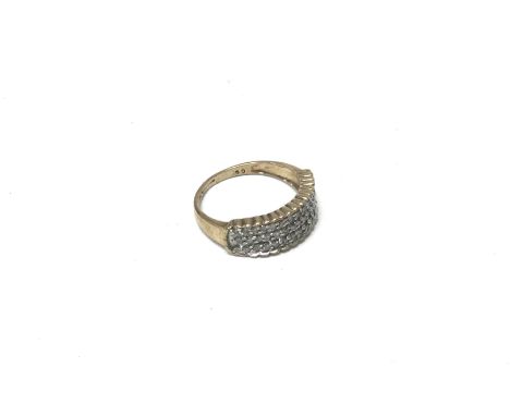 A 9ct gold three row diamond set ring. Approx 2.86 grams, size M.