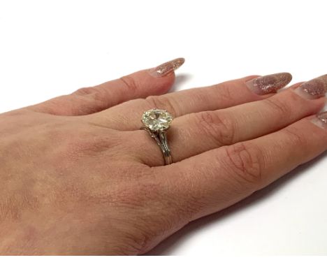 An 18ct white gold solitaire diamond ring, 3.45ct old round cut, Clarity Si, Colour L/M, (chipping to girdle) Size P. (A)