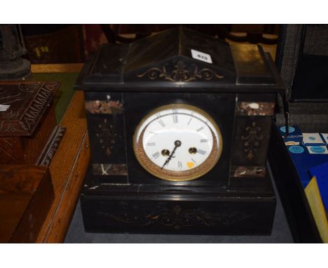 A Victorian black slate and marble eight-day chiming mantle clock, enamel roman dial.