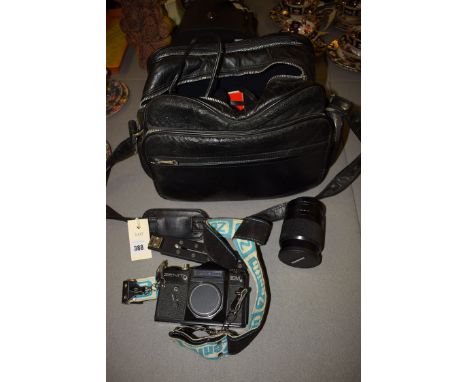 A Zenit camera no.80056711; a Hanimex lens; and others accessories in black leather bag.