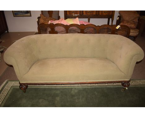 A Victorian button back settee, raised on bulbous legs on original brass castors, 70in. wide.