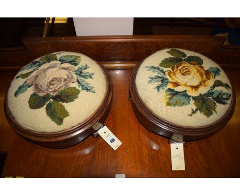 A pair of Victorian wooden footstools with tapestry tops.