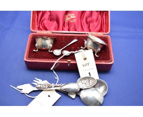 A pair of silver salts with shaped rims and spoons, by Joseph Gloster, Birmingham, 1906, in fitted red leather case; two Celt
